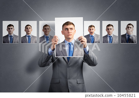 young man holds up a photograph young man holds up a photograph 10455821
