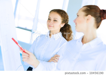 businessmen are meeting near the flipchart businessmen are meeting near the flipchart 10456190