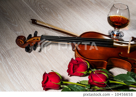 Violin, rose, glass of champagne and music books 10456658