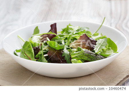 mesclun mix salad in white bowl 10460474