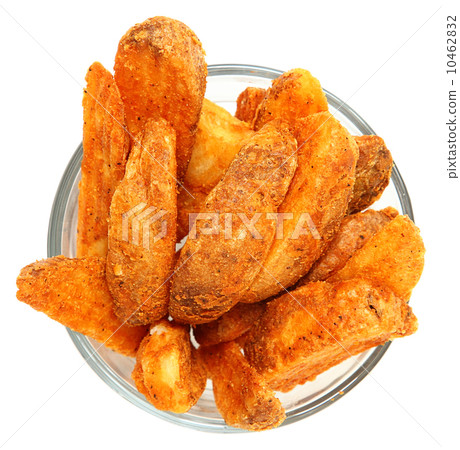Spicy Potato Wedges in Glass Bowl Over White Spicy Potato Wedges in Glass Bowl Over White 10462832
