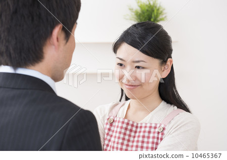 A wife connecting a husband's necktie 10465367