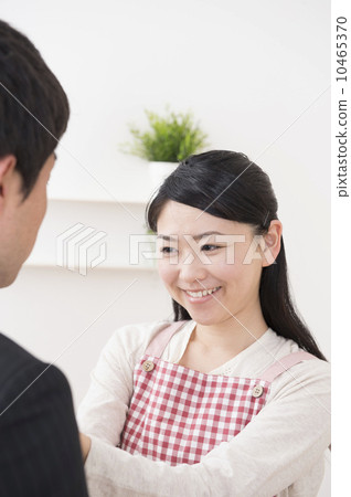 A wife connecting a husband's necktie 10465370