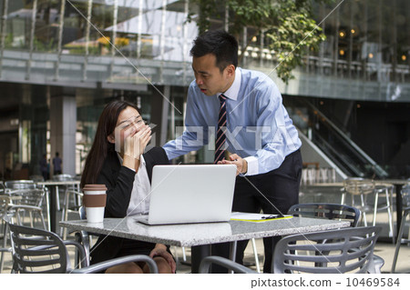 Frustrated Asian boss scolding his employee over her work Frustrated Asian boss scolding his employee over her work 10469584