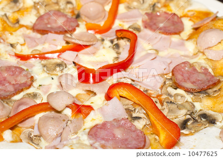 Delicious pizza with ham, peppers, mushrooms and cheese. Delicious pizza with ham, peppers, mushrooms and cheese. 10477625