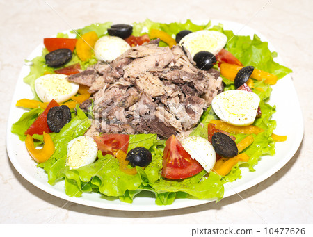 Delicious salad with tuna, tomatoes, eggs, olives and peppers. 10477626
