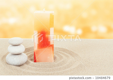 Balance zen stones and candle in sand on bokeh Balance zen stones and candle in sand on bokeh 10484679