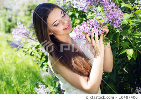 Beautiful girl with a lilac flowers Beautiful girl with a lilac flowers 10487406
