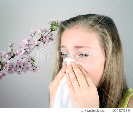 Girl blows her nose with handkerchief, health concept 10487989