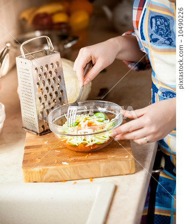 photo of housewife woman mixing salad with fork photo of housewife woman mixing salad with fork 10490226