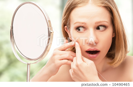 beautiful healthy woman frightened saw in the mirror acne and w beautiful healthy woman frightened saw in the mirror acne and w 10490465