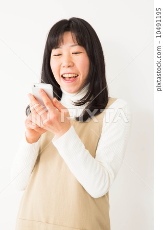 Woman operating a smartphone Woman operating a smartphone 10491195
