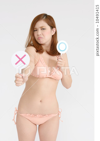 Women in swimsuit appearing cross-marks 10491415