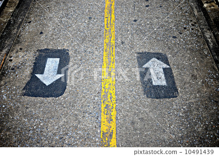 Two way sign on concrete walkway 10491439