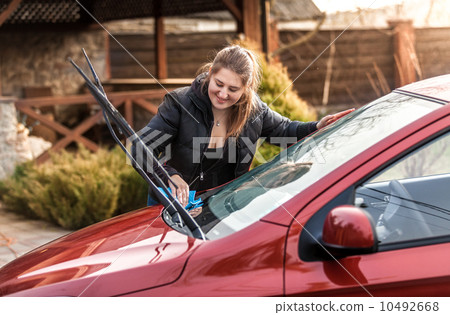 beautiful woman washing car windscreen 10492668
