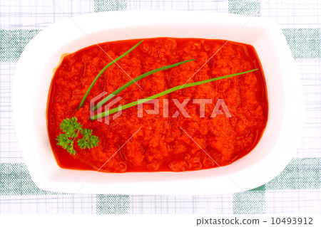Bright red ajvar in white bowl with parsley, spring onion Bright red ajvar in white bowl with parsley, spring onion 10493912