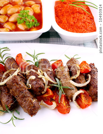 Grilled cevapcici with giant white beans and ajvar Grilled cevapcici with giant white beans and ajvar 10493914