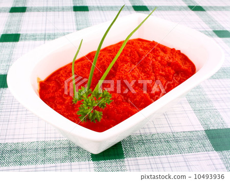 Bright red ajvar in white bowl with chives and parsley Bright red ajvar in white bowl with chives and parsley 10493936