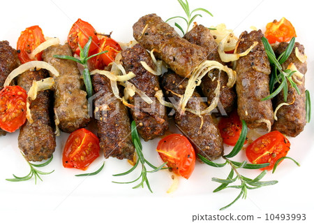 Grilled meat rolls with tomato and rosemary, close up 10493993