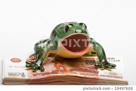 Ceramic frog on a pile of five-thousandth denominations 10497688