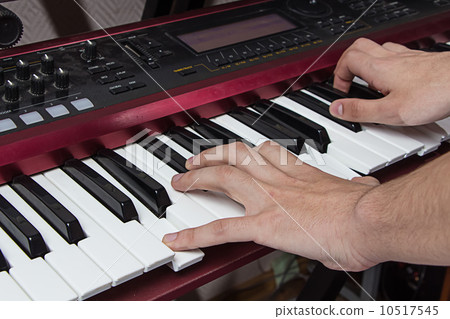 Man playing synthesizer 10517545