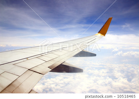 Clouds and sky as seen through window of an aircraft 10518465