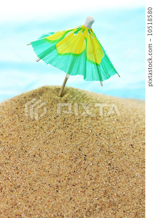 cocktail umbrella on sand cocktail umbrella on sand 10518580