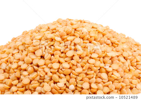 Pile of yellow split peas on white 10521489