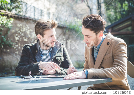 two young handsome fashion model businessmen using tablet 10526048
