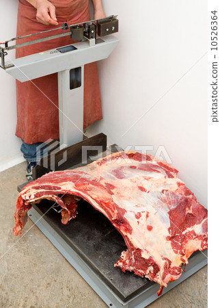 butcher weighs meat 10526364