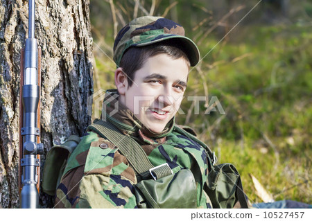 Young recruit with optical rifle in forest Young recruit with optical rifle in forest 10527457