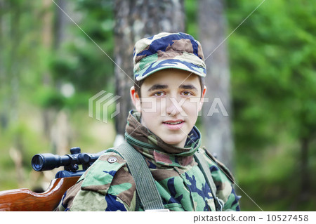 Young recruit with optical rifle in the woods Young recruit with optical rifle in the woods 10527458