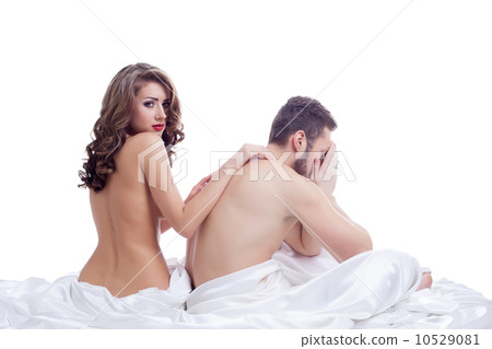 Distressed man with beautiful naked girl in bed 10529081