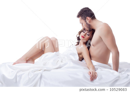 Pleased pretty woman lying in arms of her lover 10529083