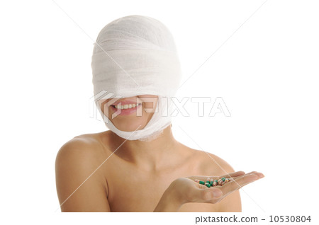 woman in bandages holding capsules woman in bandages holding capsules 10530804