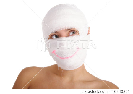 Woman with bandaged head with drawn smile Woman with bandaged head with drawn smile 10530805