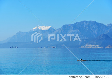 Sea bathing against snowy mountains Sea bathing against snowy mountains 10531329