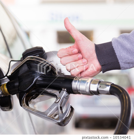 Petrol being pumped into a motor vehicle car. 10534041