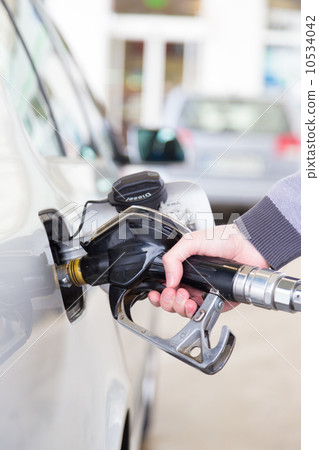 Petrol being pumped into a motor vehicle car. 10534042