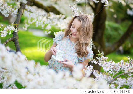 Beautiful woman in blooming cherry garden 10534178