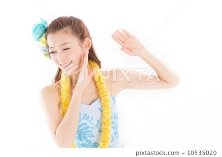 Beautiful and tropical atmosphere A beautiful woman dancing happily dressed in plenty of hula costumes Beautiful and tropical atmosphere A beautiful woman dancing happily dressed in plenty of hula costumes 10535020