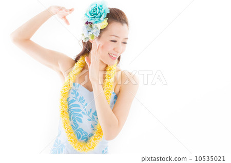Beautiful and tropical atmosphere A beautiful woman dancing happily dressed in plenty of hula costumes Beautiful and tropical atmosphere A beautiful woman dancing happily dressed in plenty of hula costumes 10535021