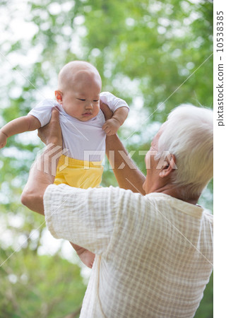 asian grandfather having fun with his son outdoor 10538385