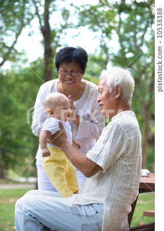 asian grandparents playing with baby grandson at outdoor 10538386