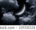 The moon in the night sky in clouds 10558328
