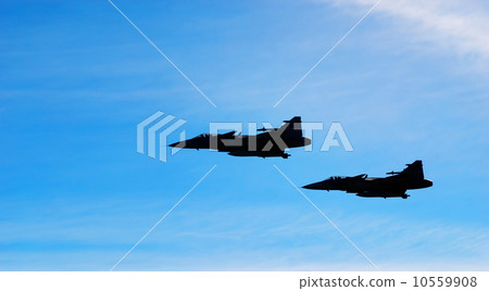 Two aircraft Jas 39 Gripen on blue sky 10559908