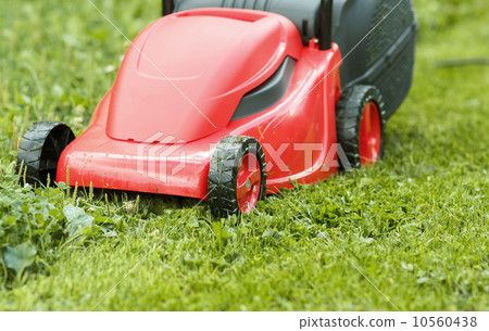 new lawnmower on green grass new lawnmower on green grass 10560438
