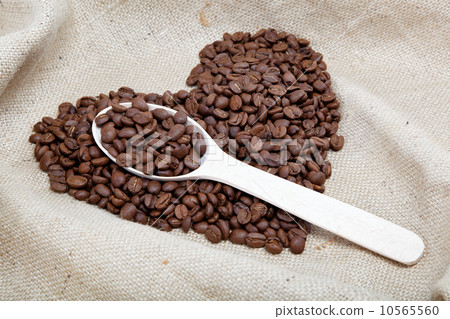 Heart of the coffee beans and wooden spoon on sacking Heart of the coffee beans and wooden spoon on sacking 10565560