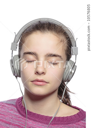 female teenager with earphones and closed eyes hears music, isol 10576805