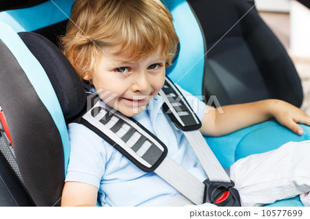 Little boy of 3 years sitting in safety car seat. 10577699
